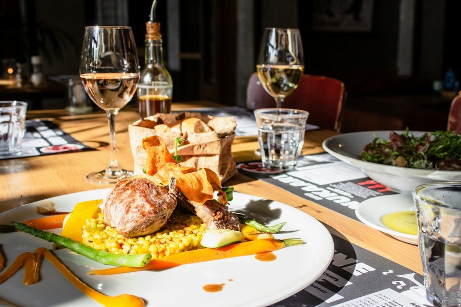 Plated dish and wine on a restaurant table