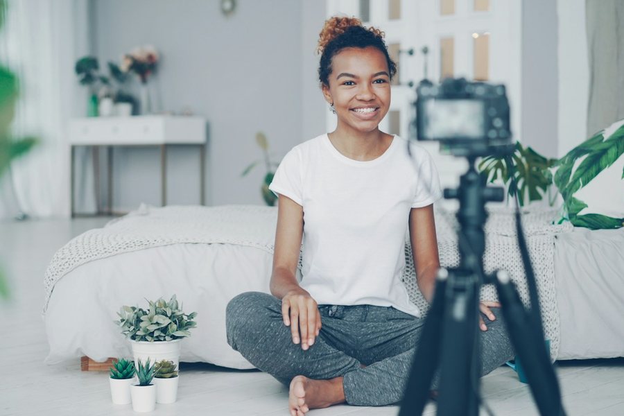 Creator filming herself with a camera on a tripod